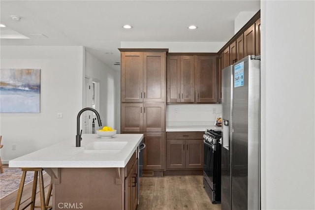 5560 Keith Rd, Paradise, CA 95969 - kitchen with appliances with stainless steel finishes, a sink, wood finished floors, recessed lighting, and light countertops