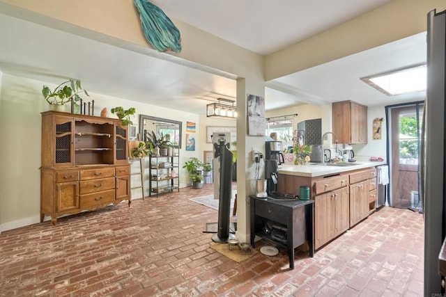 1080 Buena Pl, Carlsbad, CA 92008 - kitchen featuring a sink, light countertops, brick floors, and dishwasher