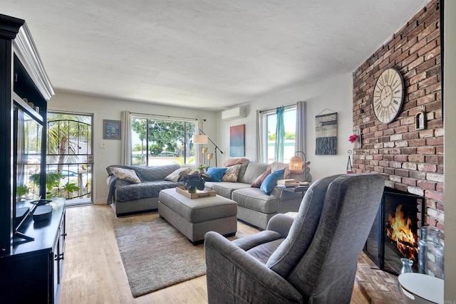 1080 Buena Pl, Carlsbad, CA 92008 - living area featuring an AC wall unit, wood finished floors, and a fireplace