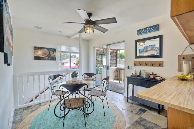 1080 Buena Pl, Carlsbad, CA 92008 - dining space featuring ceiling fan and stone tile floors
