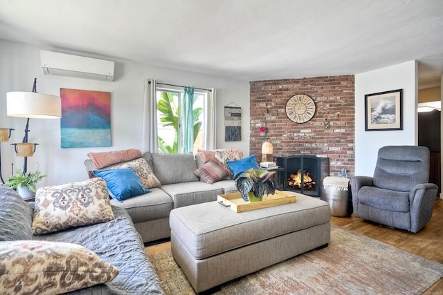 1080 Buena Pl, Carlsbad, CA 92008 - living room featuring a wall unit AC, wood finished floors, and a brick fireplace