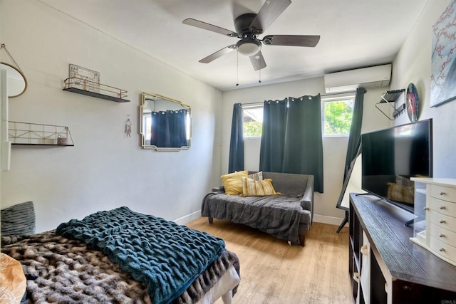 1080 Buena Pl, Carlsbad, CA 92008 - bedroom with a wall mounted AC, light wood-style flooring, baseboards, and a ceiling fan