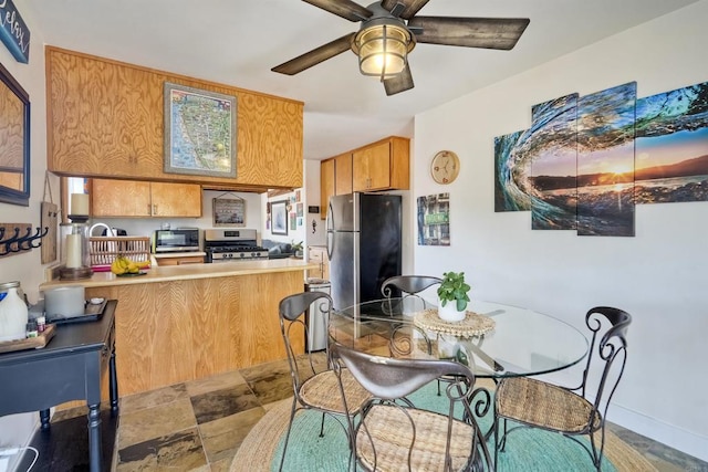 1080 Buena Pl, Carlsbad, CA 92008 - kitchen with stainless steel appliances, a peninsula, a ceiling fan, light countertops, and stone finish floors