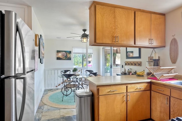 1080 Buena Pl, Carlsbad, CA 92008 - kitchen featuring freestanding refrigerator, a peninsula, ceiling fan, light countertops, and brown cabinets