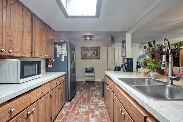 1080 Buena Pl, Carlsbad, CA 92008 - kitchen featuring white microwave, a sink, baseboards, and brown cabinetry