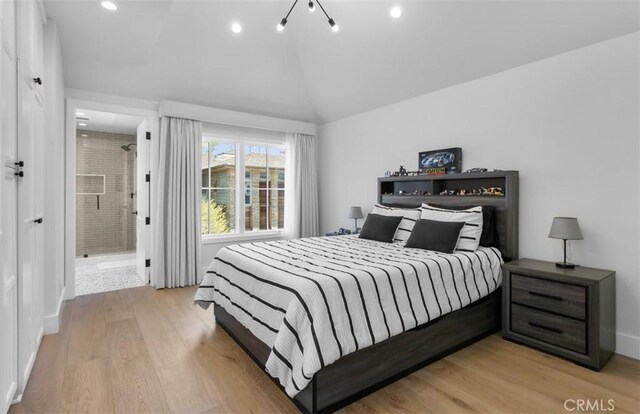 2401 Bayshore Dr, Newport Beach, CA 92663 - bedroom with light wood-type flooring, vaulted ceiling, recessed lighting, baseboards, and connected bathroom