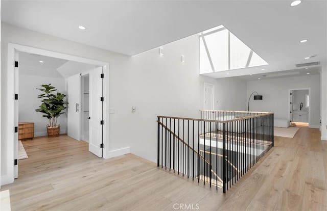 2401 Bayshore Dr, Newport Beach, CA 92663 - hall featuring an upstairs landing, light wood finished floors, recessed lighting, and baseboards