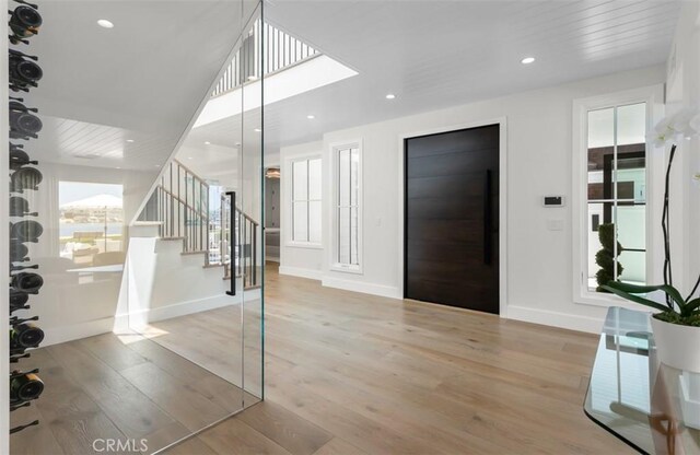 2401 Bayshore Dr, Newport Beach, CA 92663 - entryway featuring plenty of natural light, stairway, wood finished floors, and recessed lighting