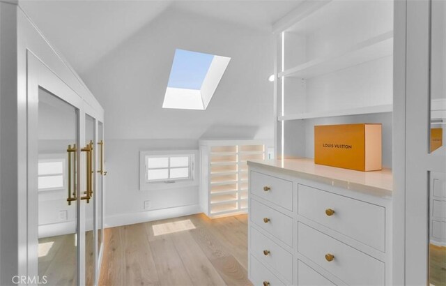 2401 Bayshore Dr, Newport Beach, CA 92663 - walk in closet with a skylight, vaulted ceiling, and light wood-style flooring