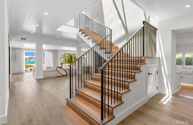 2401 Bayshore Dr, Newport Beach, CA 92663 - stairway featuring hardwood / wood-style floors, recessed lighting, wooden ceiling, and baseboards