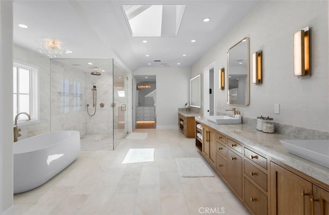 2401 Bayshore Dr, Newport Beach, CA 92663 - full bath with a shower stall, a skylight, double vanity, a soaking tub, and recessed lighting
