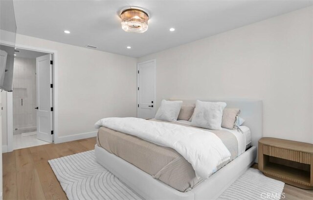 2401 Bayshore Dr, Newport Beach, CA 92663 - bedroom with light wood finished floors, recessed lighting, baseboards, and ensuite bath