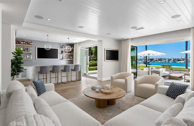 2401 Bayshore Dr, Newport Beach, CA 92663 - living room with light wood-type flooring, healthy amount of natural light, bar area, baseboards, and recessed lighting