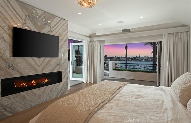 2401 Bayshore Dr, Newport Beach, CA 92663 - bedroom with access to outside, wood finished floors, a fireplace, and recessed lighting