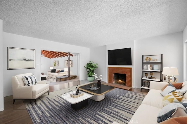 2931 W 137th St, Gardena, CA 90249 - living room with wood finished floors, a textured ceiling, and a fireplace