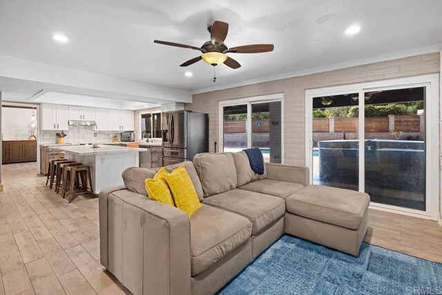 9739 Carta Ln, El Cajon, CA 92021 - living area featuring light wood-style floors, ceiling fan, ornamental molding, and recessed lighting