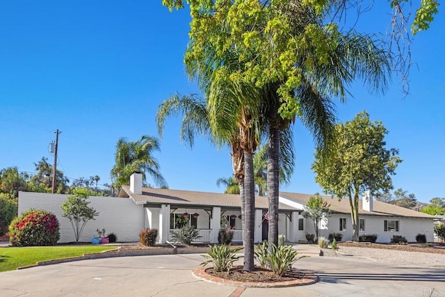 9739 Carta Ln, El Cajon, CA 92021 - ranch-style house with curved driveway, a chimney, and a porch