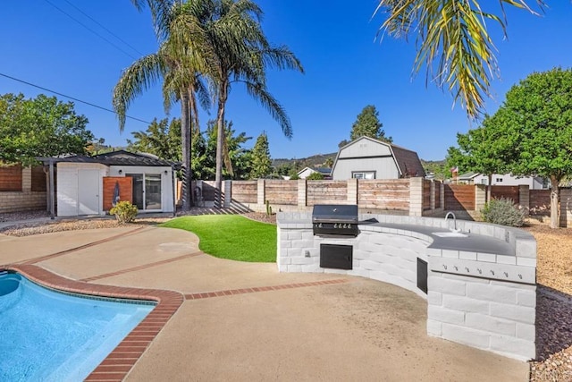 9739 Carta Ln, El Cajon, CA 92021 - fenced backyard with a patio, an outbuilding, and a sink