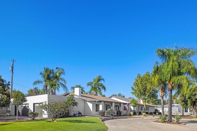 9739 Carta Ln, El Cajon, CA 92021 - view of front facade with a garage, a front lawn, and a chimney