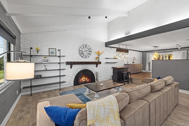 9739 Carta Ln, El Cajon, CA 92021 - living area with plenty of natural light, a lit fireplace, wood finished floors, and baseboards