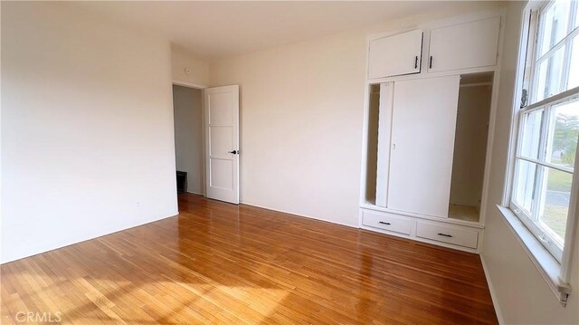 8739 Ralph St, Rosemead, CA 91770 - unfurnished bedroom featuring multiple windows and light wood finished floors