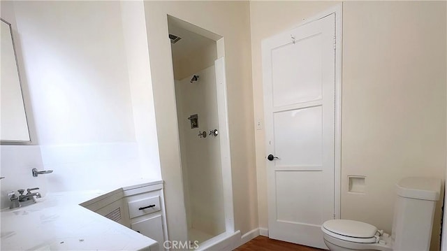 8739 Ralph St, Rosemead, CA 91770 - bathroom featuring a shower stall, toilet, vanity, and wood finished floors