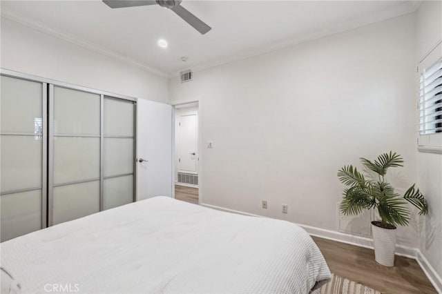 450 San Vicente Blvd Unit 203, Santa Monica, CA 90402 - bedroom featuring wood finished floors, baseboards, ornamental molding, a closet, and ceiling fan