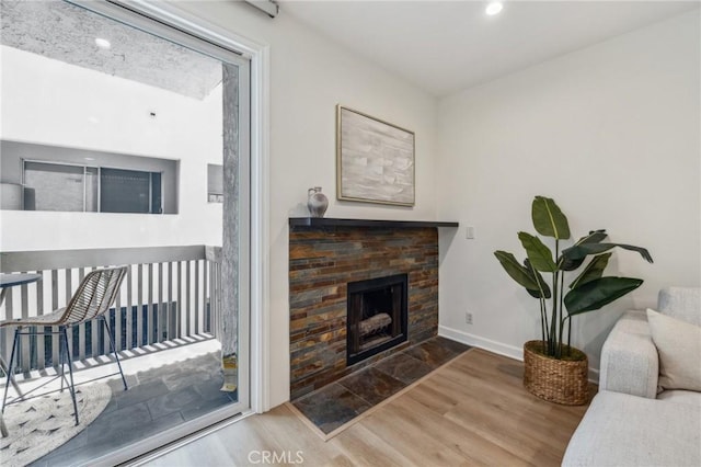 450 San Vicente Blvd Unit 203, Santa Monica, CA 90402 - living room featuring wood finished floors, a fireplace with flush hearth, baseboards, and recessed lighting