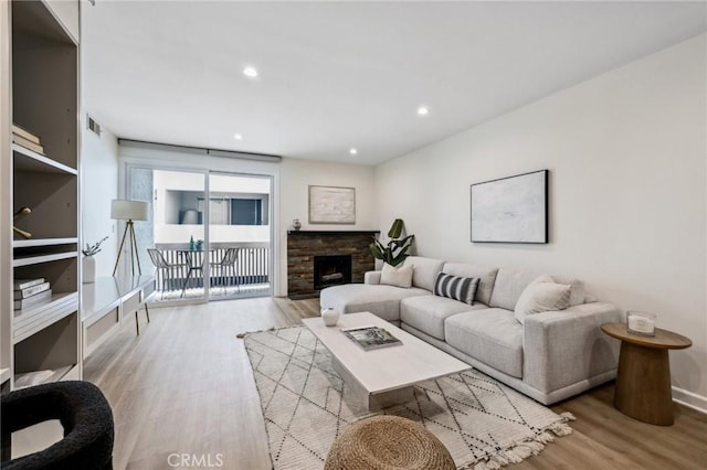 450 San Vicente Blvd Unit 203, Santa Monica, CA 90402 - living area featuring wood finished floors, recessed lighting, baseboards, and a stone fireplace