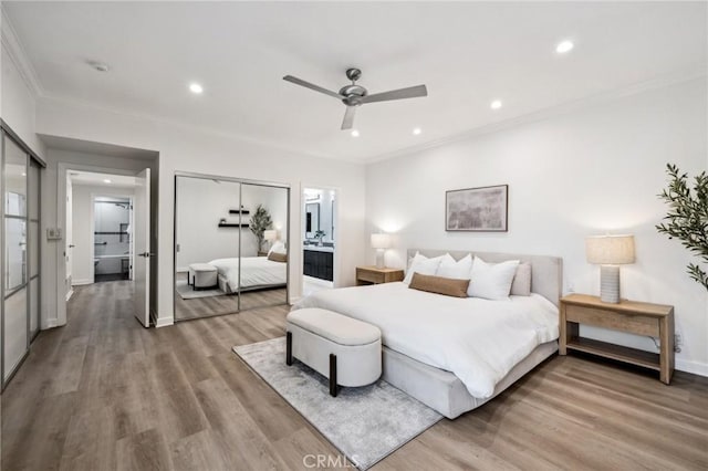 450 San Vicente Blvd Unit 203, Santa Monica, CA 90402 - bedroom with crown molding, wood finished floors, recessed lighting, a closet, and baseboards