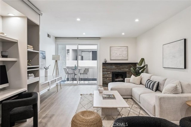 450 San Vicente Blvd Unit 203, Santa Monica, CA 90402 - living area featuring wood finished floors, recessed lighting, and a stone fireplace
