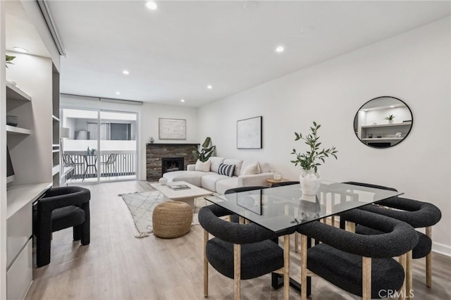450 San Vicente Blvd Unit 203, Santa Monica, CA 90402 - living area with wood finished floors, recessed lighting, a fireplace, and baseboards