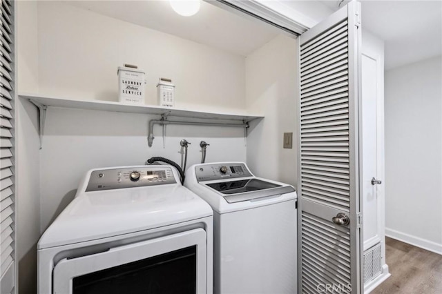 450 San Vicente Blvd Unit 203, Santa Monica, CA 90402 - laundry room featuring wood finished floors, independent washer and dryer, and baseboards