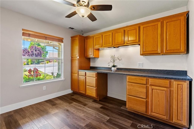 1534 Via Arroyo, Paso Robles, CA 93446 - kitchen with baseboards, brown cabinets, dark countertops, a ceiling fan, and dark wood-type flooring
