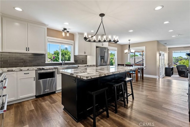 1534 Via Arroyo, Paso Robles, CA 93446 - kitchen with appliances with stainless steel finishes, a chandelier, a sink, dark wood-style floors, and a center island