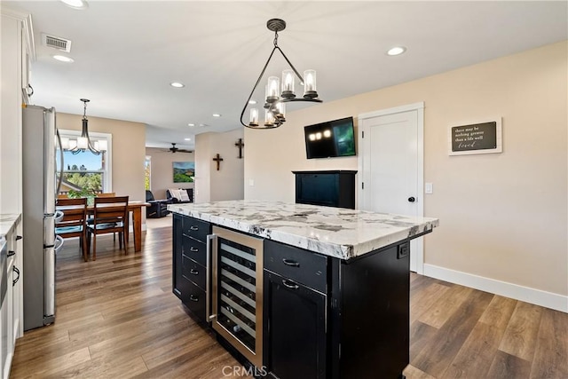 1534 Via Arroyo, Paso Robles, CA 93446 - kitchen featuring dark cabinetry, wine cooler, a chandelier, wood finished floors, and recessed lighting