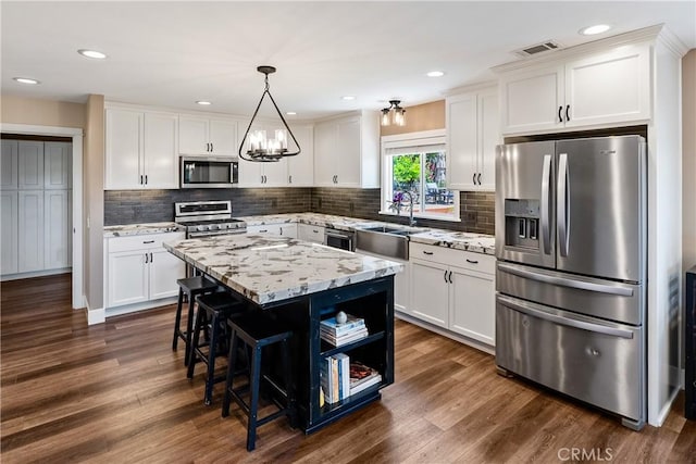 1534 Via Arroyo, Paso Robles, CA 93446 - kitchen with appliances with stainless steel finishes, a sink, white cabinetry, a chandelier, and a kitchen island