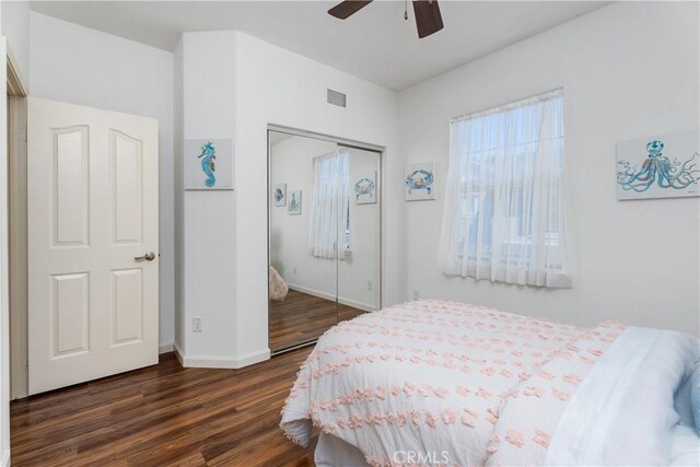 6249 Pacific Pointe Dr Unit 16, Huntington Beach, CA 92648 - bedroom featuring wood finished floors, a closet, baseboards, and a ceiling fan