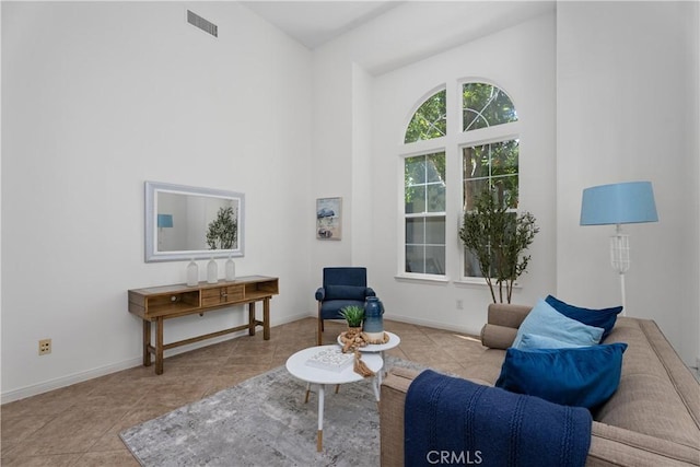 6249 Pacific Pointe Dr Unit 16, Huntington Beach, CA 92648 - sitting room featuring high vaulted ceiling, tile patterned flooring, and baseboards