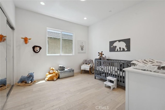 1746 Garfield Pl Unit 203, Los Angeles, CA 90028 - bedroom featuring light wood-type flooring, recessed lighting, a closet, and a nursery area