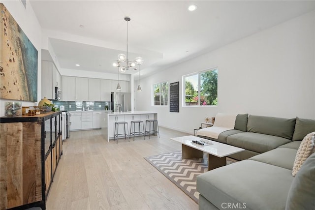 1746 Garfield Pl Unit 203, Los Angeles, CA 90028 - living room with light wood-style flooring, recessed lighting, a chandelier, and baseboards