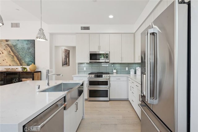 1746 Garfield Pl Unit 203, Los Angeles, CA 90028 - kitchen with appliances with stainless steel finishes, a sink, light wood-type flooring, light countertops, and recessed lighting