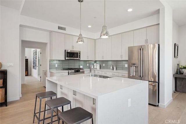 1746 Garfield Pl Unit 203, Los Angeles, CA 90028 - kitchen featuring stainless steel appliances, baseboards, a sink, light wood finished floors, and recessed lighting