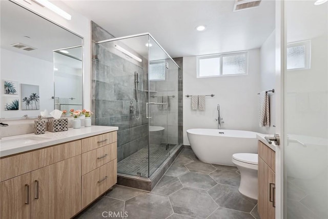 1746 Garfield Pl Unit 203, Los Angeles, CA 90028 - bathroom featuring vanity, a stall shower, a freestanding bath, toilet, and tile patterned floors