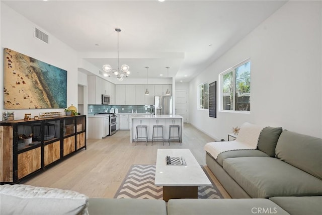 1746 Garfield Pl Unit 203, Los Angeles, CA 90028 - living room with light wood-type flooring and a chandelier