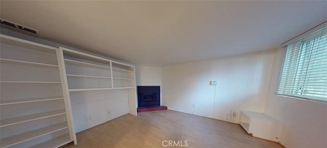4660 Coldwater Canyon Ave Unit 4, Studio City, CA 91604 - unfurnished room featuring a fireplace with raised hearth and wood finished floors