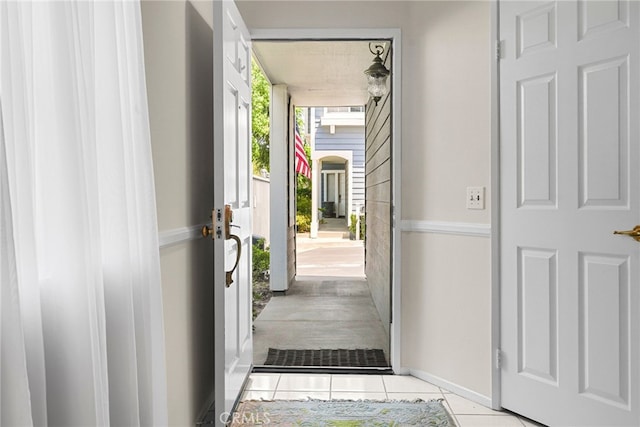 15058 Providence Ln, North Hills, CA 91343 - doorway with tile patterned flooring and baseboards