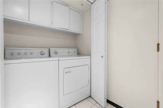 15058 Providence Ln, North Hills, CA 91343 - washroom with cabinet space, separate washer and dryer, and light tile patterned flooring