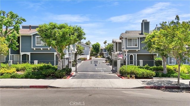 15058 Providence Ln, North Hills, CA 91343 - view of concrete street with curbs, a gate, a residential view, and a gated entry