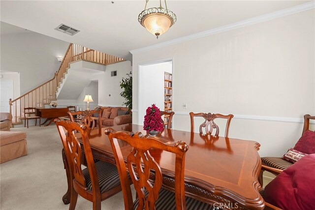 15058 Providence Ln, North Hills, CA 91343 - dining area with stairway, light colored carpet, and ornamental molding